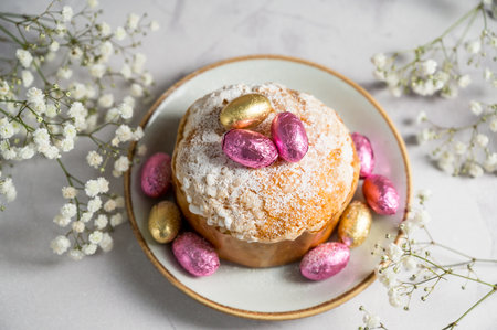 Easter cake with chocolate easter eggs and gypsophila flowers, top view. Spring holidaysの写真素材