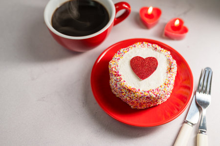 Valentines Day or Mothers Day bento cake with red heart, cup of coffee and candles. Copy spaceの写真素材