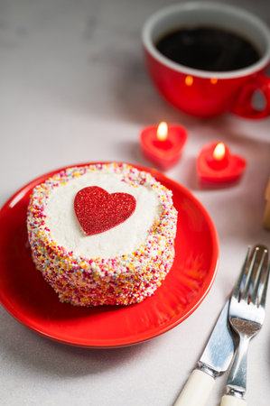 Valentines Day or Mothers Day bento cake with red heart, cup of coffee and candles. Copy spaceの写真素材