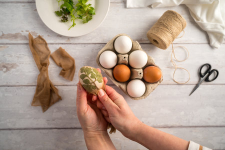 DIY Easter eggs with natural leaves, creating patterns on eggs using plants.の写真素材
