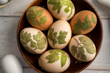 DIY Easter eggs with natural leaves, creating patterns on eggs using plants.の写真素材