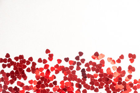 Hearts sequins on a white background, flat lay top viewの写真素材