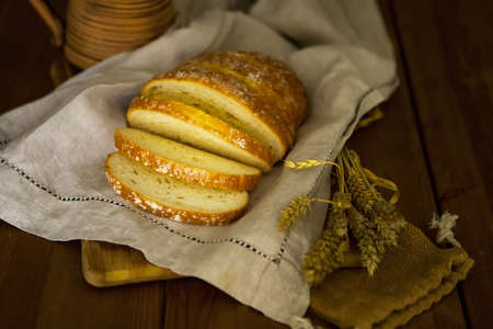fresh baked bread on a wooden table - healthy food concept