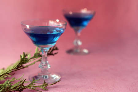 Blue curacao alcohol coctail on a pink background