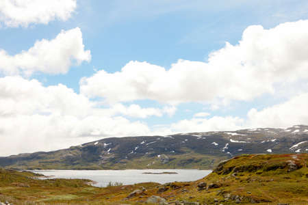 Snowy mountains and blue cold sky at Norwegian fjord coast