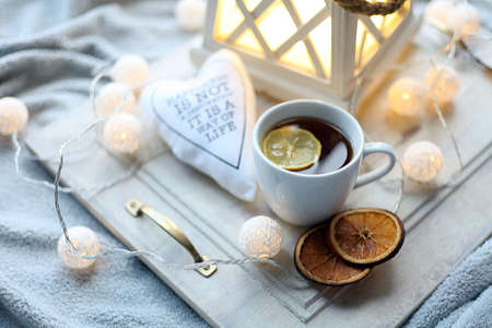 nuts and a cup of coffee on a gray wooden table. Bright colors. Coffee pause. Citrus candies