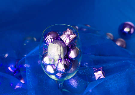 Christmas background with glasses of wine and ornaments over white. vine glass with christmas...
