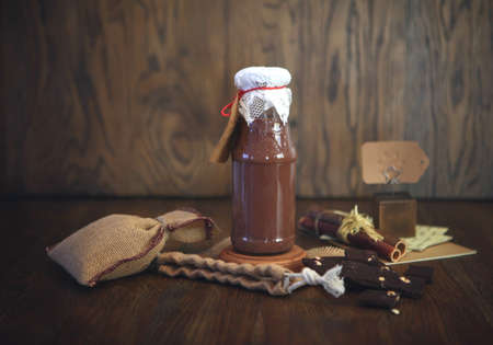 chocolate Smoothie at the bottle. Colorful drink in bottle with organic chocolate and superfoods on...