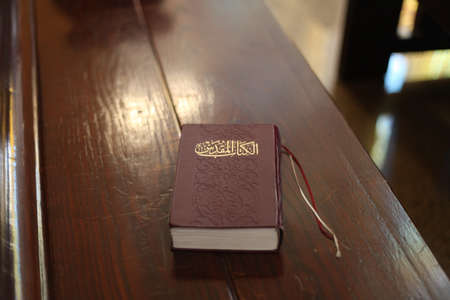 Holy Bible on a old wooden church bench.の写真素材