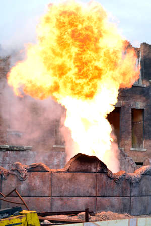 building on fire. flames and smoke rise from burning apartments building. ash everywhere