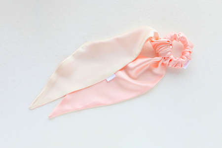 Pink silk Scrunchy isolated on white. Flat lay Hairdressing tools and accessories as Color Hair Scrunchies, Elastic Hair Bands, Bobble Sports Scrunchie Hairbandの写真素材