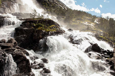 Road in Norway passing over the waterfall Langfoss. National tourist routeの写真素材
