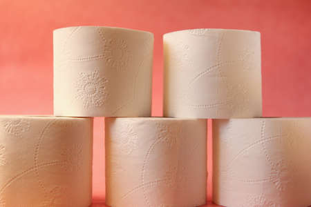 Soft, white toilet paper roll on pink pastel bright background. Hygiene concept. Empty place for...