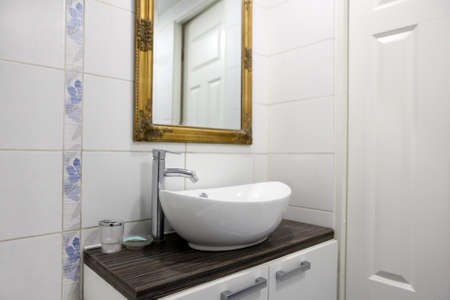 sink at bathroom. modern bathroom with white ceramic sink and mirror. empty apartmentsの写真素材