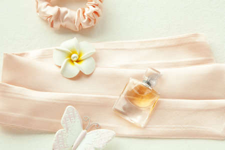 Perfume in beautiful bottle and flower on pinkの写真素材