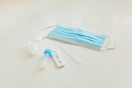 negative sars covid antigen test with mask. equipment at medical laboratory on white table