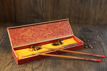 chopsticks and rest in the traditional box on dark oak wooden table. bamboo reusable chopsticksの写真素材