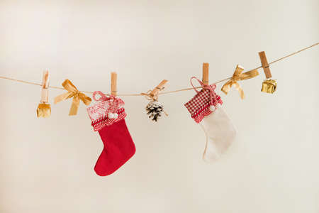 christmas socks, golden presents and decorations on the rope on white backgroundの写真素材