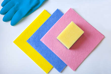 cleaning rugs and glove-colorful sponges, rubber gloves for cleaning on a white background, flat...