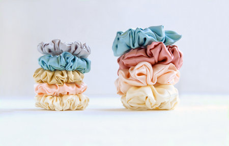 pyramids of silk beige Scrunchies on white. Luxury Hair accessories. Elastic Bands, Bobble Hairbandの写真素材