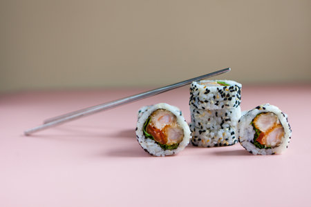 sushi rolls with shrimp on pink background. reusable sushi sticks. Food Photo.varieties of sushiesの写真素材