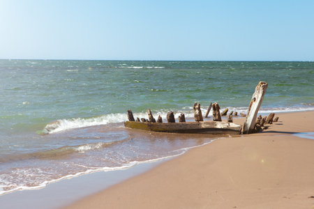 remains of old boat on shore. wooden longtail covered by sand. Travel landscape tropical sea beachの写真素材