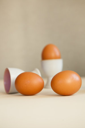 brown easter eggs on the table. Eggs chicken on beige background