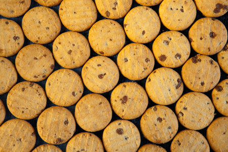 cookies flat lay with chocolate. From above delicious sweet chips on table against black backgroundの写真素材