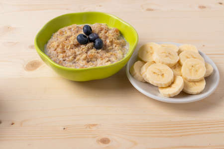 oat meal porridge as healthy organic vegan breakfast concept