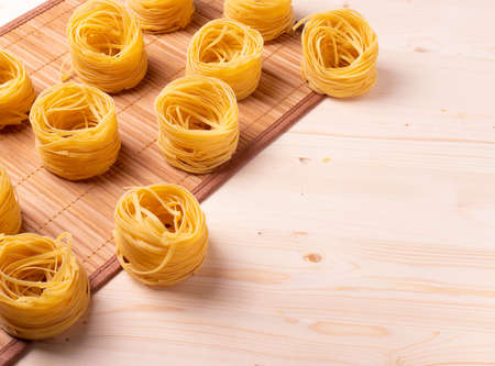 italian dry pasta on wooden surfaceの写真素材