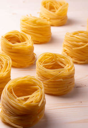 italian dry pasta on wooden surfaceの写真素材