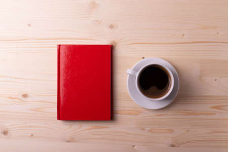 a white ceramic cup with black espresso, french croissant as breakfast or snack concept on rustic, natural texture wooden surfaceの写真素材