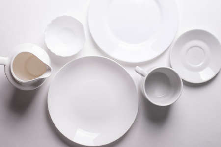 a group of different white ceramic plates on white backgroundの写真素材