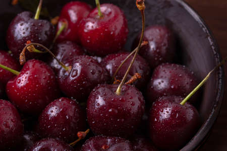 fresh ripen dark red cherries with water drops, close up.