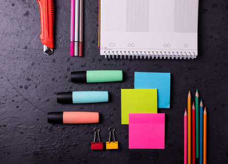 different stationary items on dark concrete surfaceの写真素材