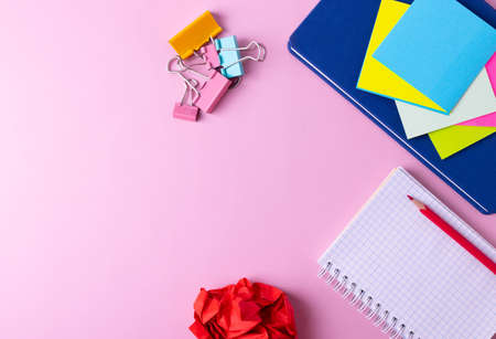 different stationary items and notebooks on the yellow background. minimalism. flat layの写真素材