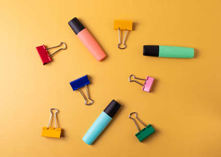 different stationary items and notebooks on the yellow background. minimalism. flat layの写真素材