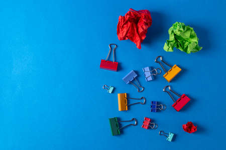 different stationary items and notebooks on the blue background. minimalism. flat lay