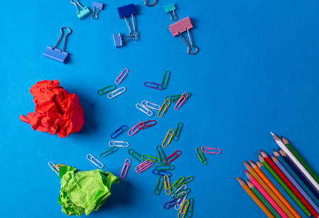different stationary items and notebooks on the blue background. minimalism. flat lay