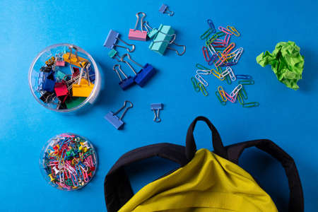 different stationary items and notebooks on the blue background. minimalism. flat lay