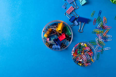 different stationary items and notebooks on the blue background. minimalism. flat lay