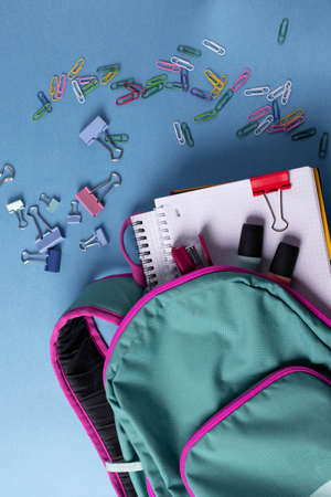 different stationary items and notebooks on the blue background. minimalism. flat layの写真素材