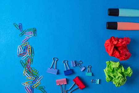 different stationary items and notebooks on the blue background. minimalism. flat lay