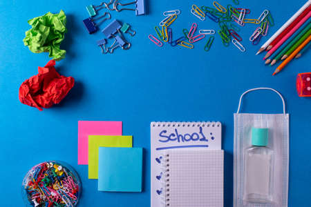 different stationary items on the blue background. minimalism. flat layの写真素材