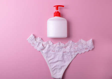 beautiful lingerie and a container bottle with liquid body wash