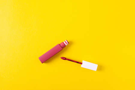 female bright lipsticks on mono colour yellow backgroundの写真素材