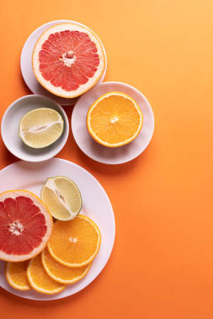 citruses cut in slices on light backgroundの写真素材
