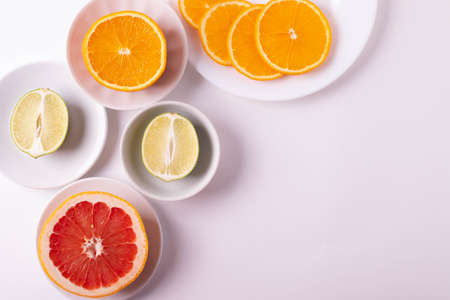 citruses cut in slices on light backgroundの写真素材
