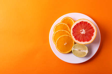 citruses cut in slices on light backgroundの写真素材