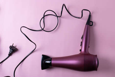 hairdresser's or hair care concept with different items on pale pink background. minimalism style. flat lay. top viewの写真素材